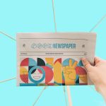 person holding newspaper article